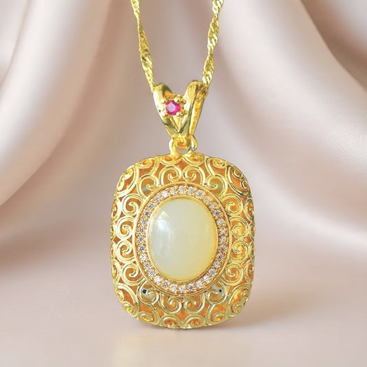 A necklace featuring a gold-tone pendant .Gold-Tone Openwork Scrollwork Box Pendant Necklace Embellished with Zircons, Luxurious & Elegant