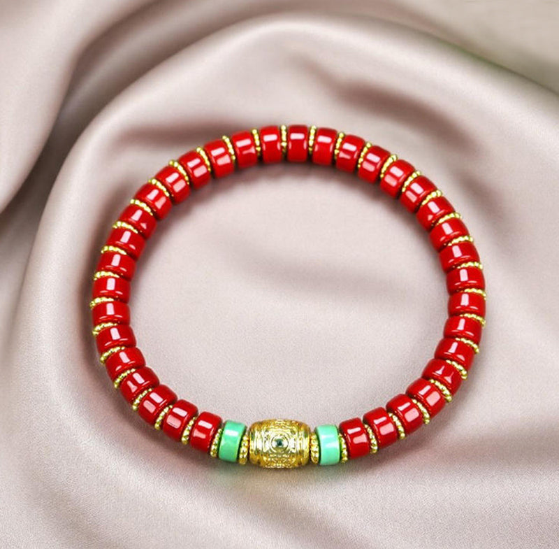 Red coral pill beads, gold serrated spacer bracelet, turquoise,  gold barrel beads, festive and opulent Tibetan style.
