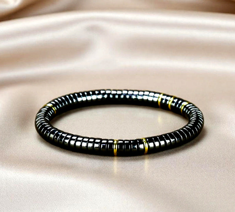 Black Terahertz Bead and Gold Spacer Elastic Bracelet – A stylish, minimalist, unisex magnetic therapy accessory featuring a striking gold-and-black contrast.