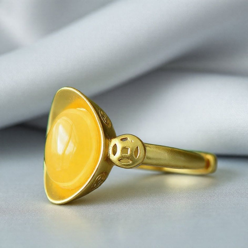 Oval amber ring with openwork ancient coin design, gold accents, warm and lustrous amber, elegant and luxurious design, comes in a beautiful gift box.