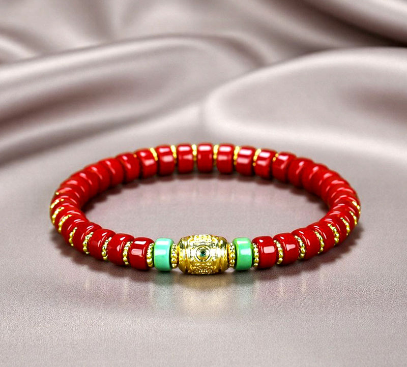 Red coral pill beads, gold serrated spacer bracelet, turquoise,  gold barrel beads, festive and opulent Tibetan style.