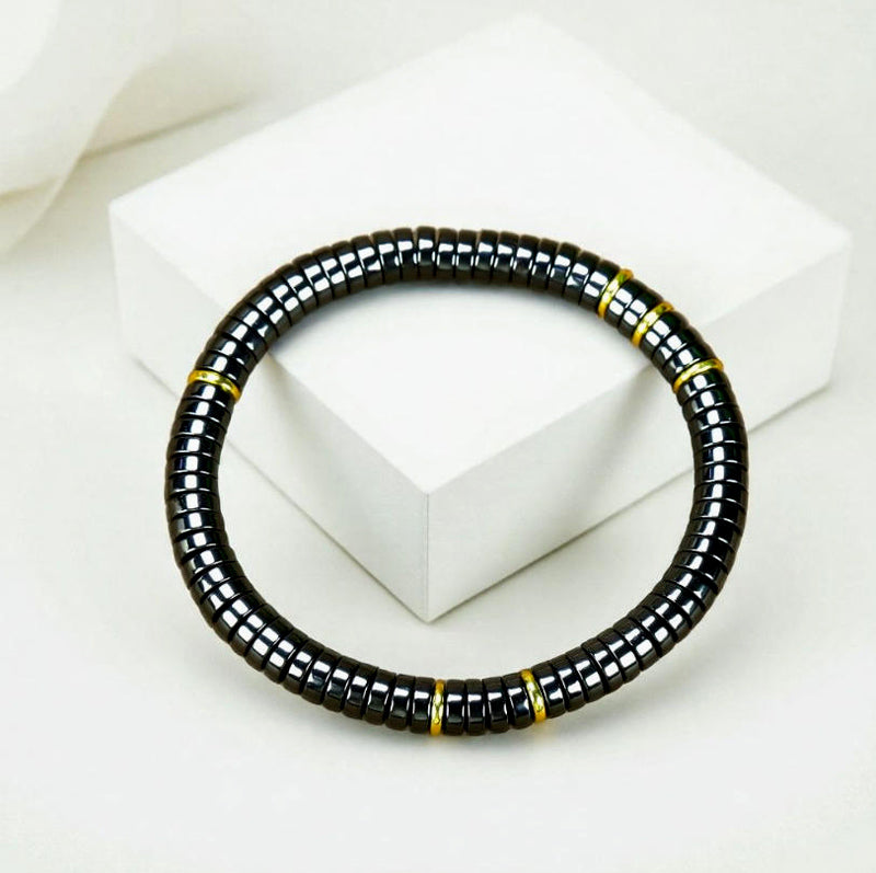 Black Terahertz Bead and Gold Spacer Elastic Bracelet – A stylish, minimalist, unisex magnetic therapy accessory featuring a striking gold-and-black contrast.
