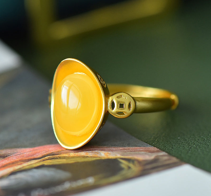Oval amber ring with openwork ancient coin design, gold accents, warm and lustrous amber, elegant and luxurious design, comes in a beautiful gift box.