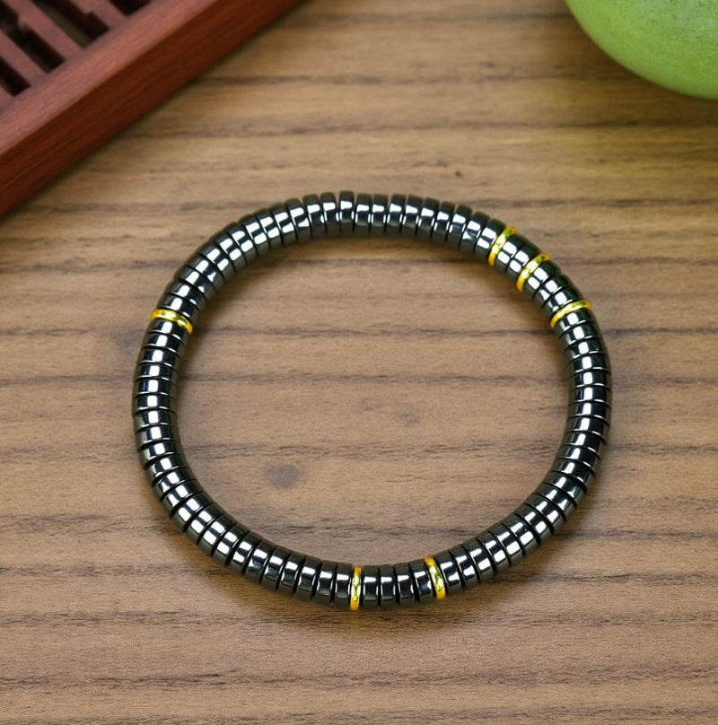 Black Terahertz Bead and Gold Spacer Elastic Bracelet – A stylish, minimalist, unisex magnetic therapy accessory featuring a striking gold-and-black contrast.