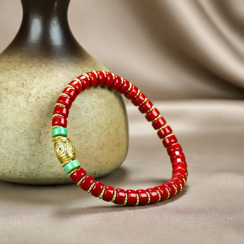 Red coral pill beads, gold serrated spacer bracelet, turquoise,  gold barrel beads, festive and opulent Tibetan style.