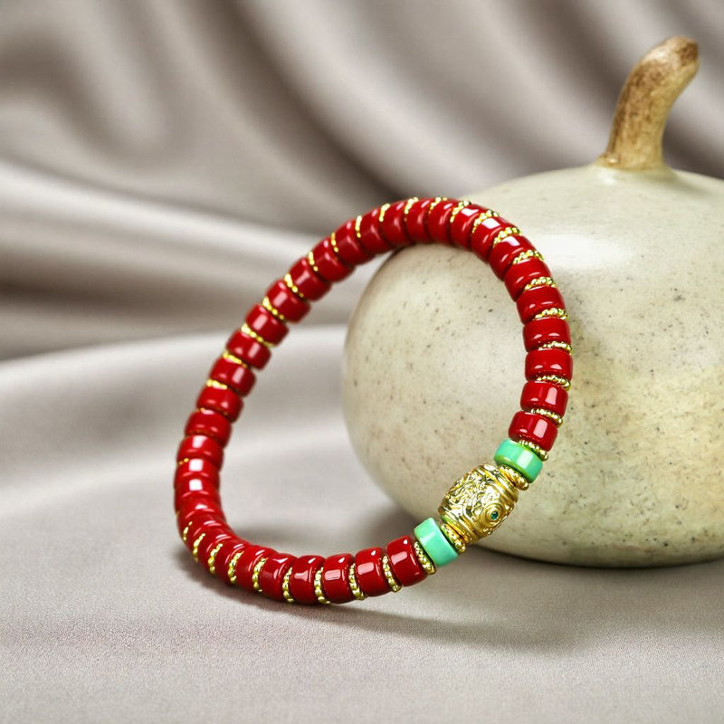 Red coral pill beads, gold serrated spacer bracelet, turquoise,  gold barrel beads, festive and opulent Tibetan style.