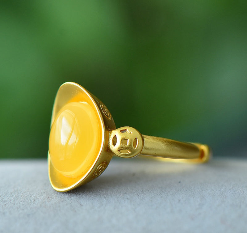Oval amber ring with openwork ancient coin design, gold accents, warm and lustrous amber, elegant and luxurious design, comes in a beautiful gift box.