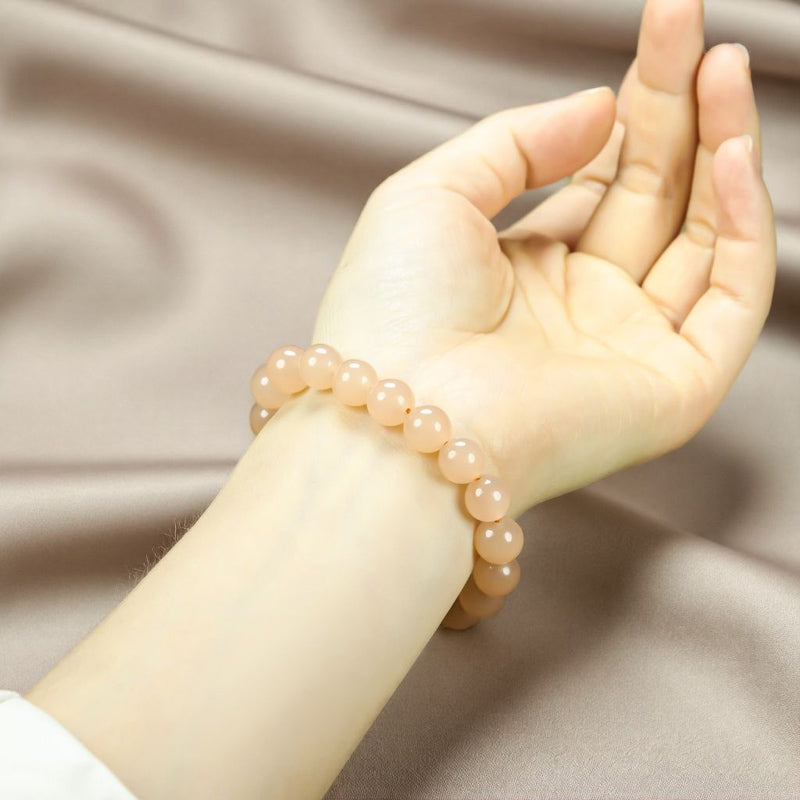 Creamy white chalcedony elastic bracelet with large round beads smooth and lustrous like fine jade, minimalist and pure, exuding elegant sophistication.