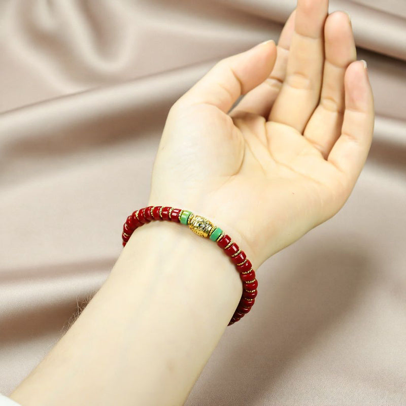 Red coral pill beads, gold serrated spacer bracelet, turquoise,  gold barrel beads, festive and opulent Tibetan style.