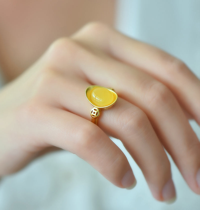 Oval amber ring with openwork ancient coin design, gold accents, warm and lustrous amber, elegant and luxurious design, comes in a beautiful gift box.